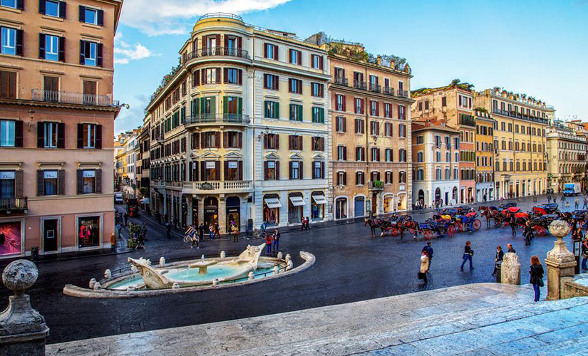 فواره برنینی و کالسکه های توریستی در میدان اسپانیا شهر رم